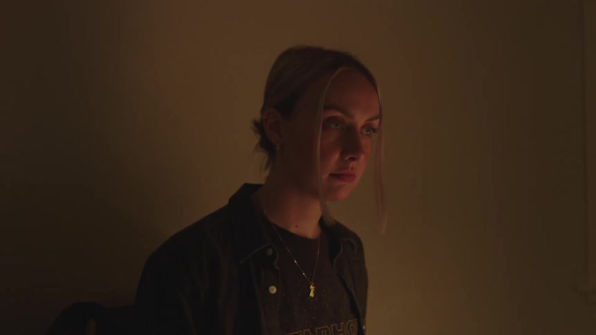 Portrait of a blonde woman playing a digital music keyboard
