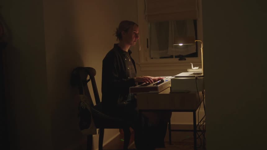 A clip of a lady playing a piano