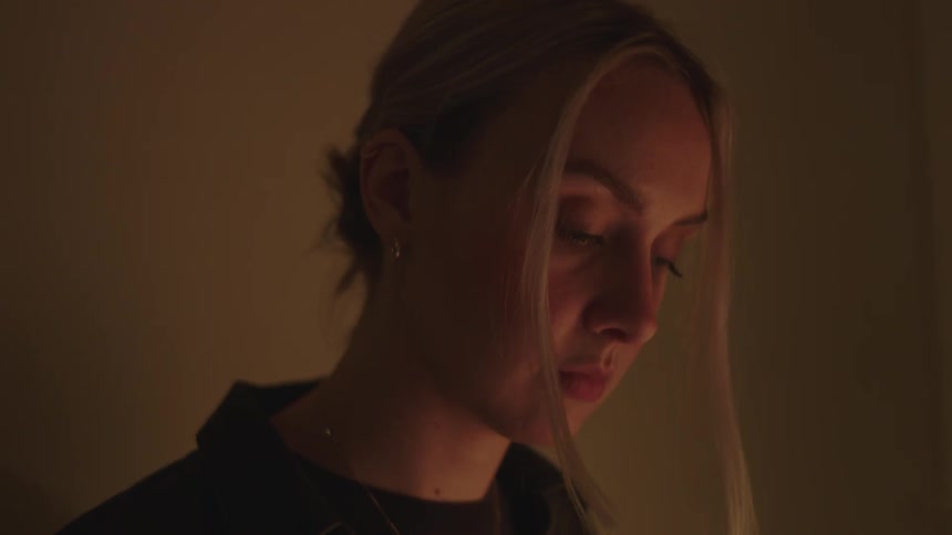 Portrait of a young blonde woman playing a digital piano