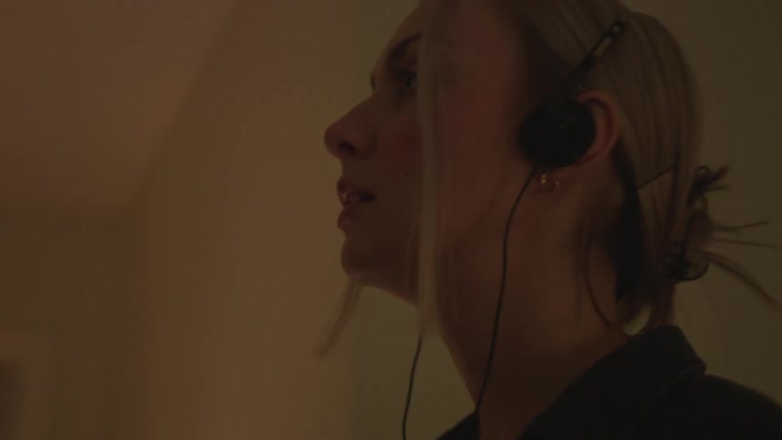 Closeup of a womans face listening to music on headphones