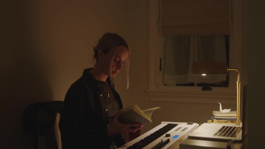 A woman begins typing on her laptop