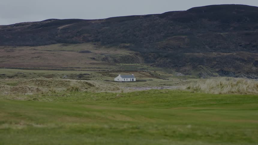 House on open rural land near a mountain