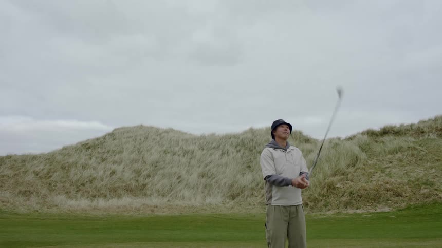 A man plays golf and does cool tricks with the club