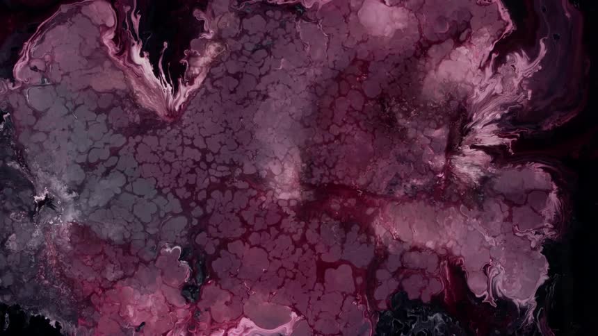 Extreme closeup of red and white liquid in slow and abstract motion