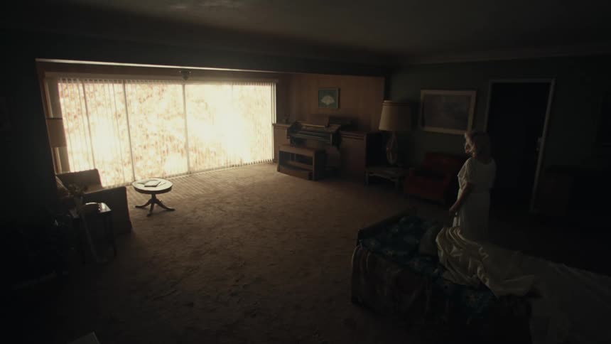 Woman in long pajamas walking in a room