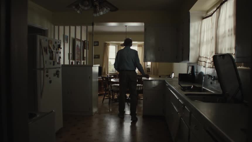 A man walks out of the kitchen