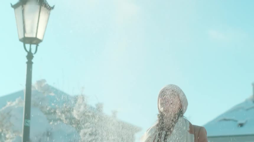 Woman throwing snow up in the air