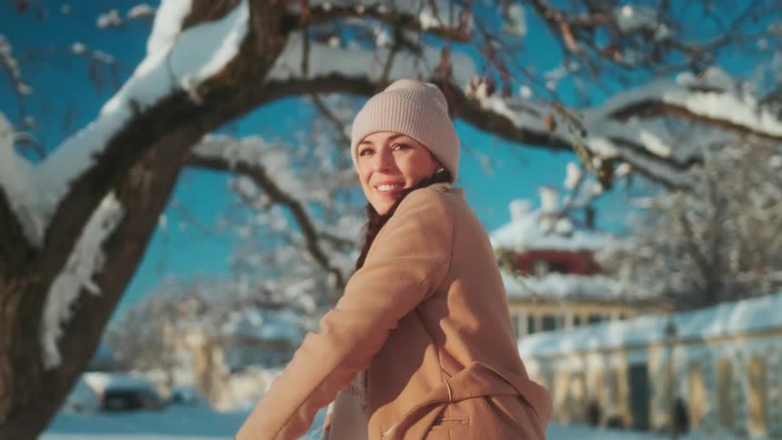 Happy woman throwing a snow ball