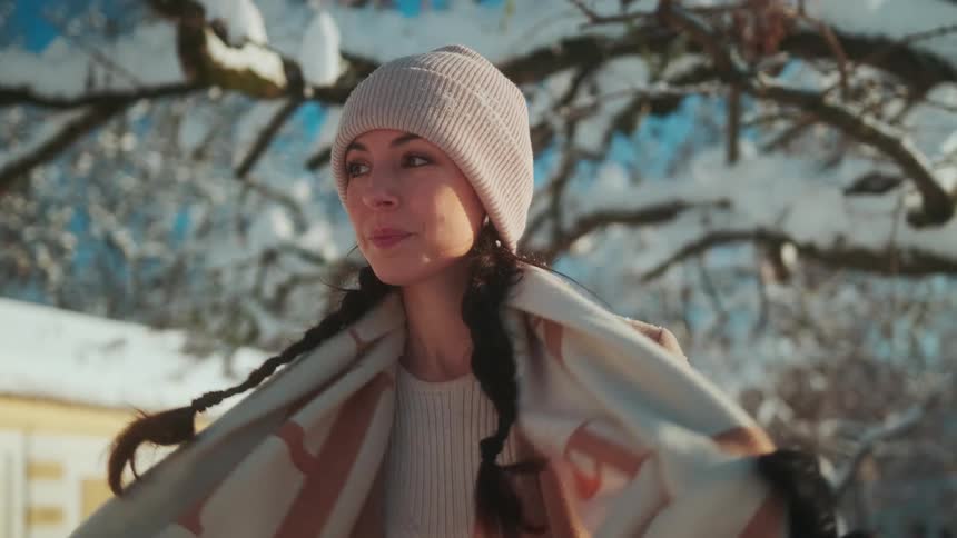 An elegantly dressed woman walking in the snow