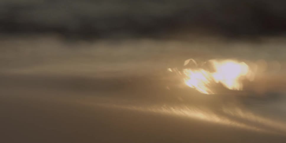 Waves gently move onto a beach at dawn
