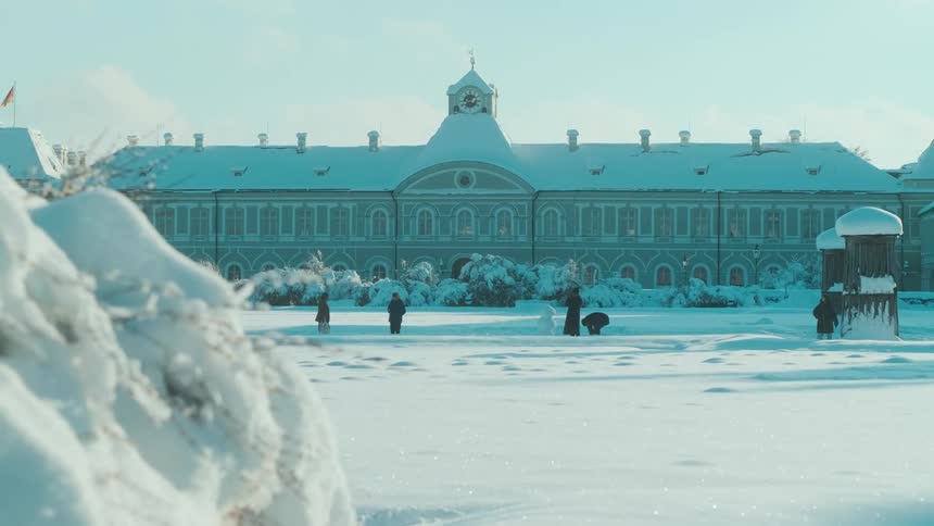 People walking through a city covered in snow