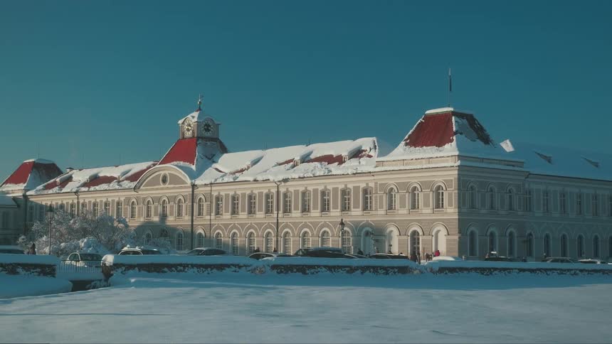 A clip of a castle building covered with snow on the roof