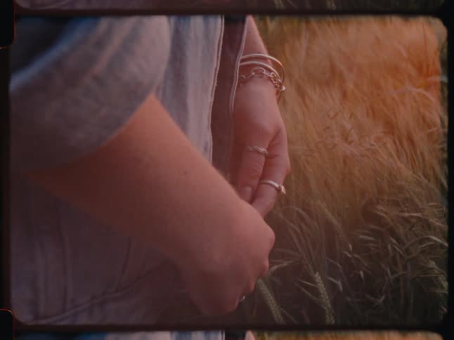 Closeup of a womans hands in the middle of a field