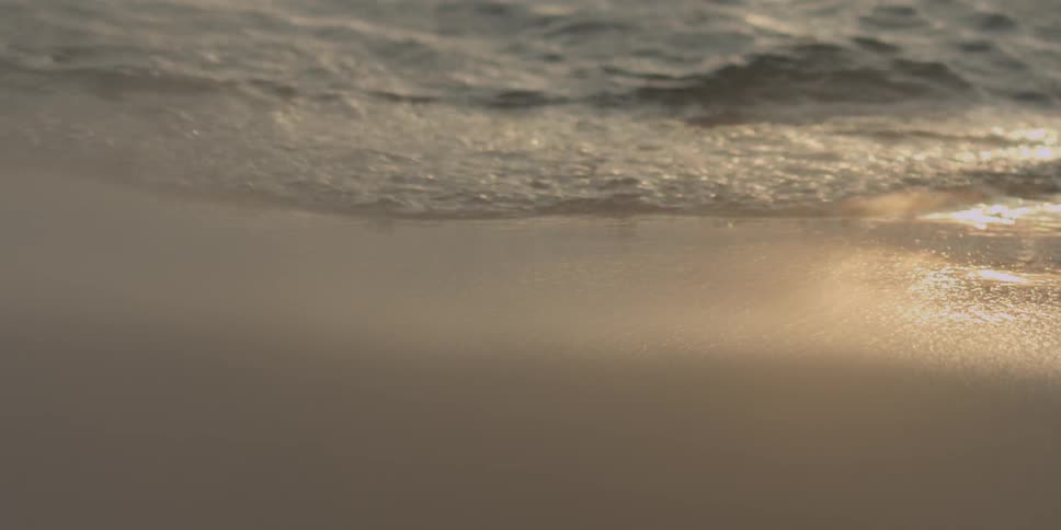Glistening water flows onshore