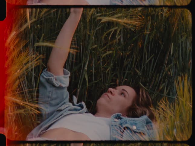 Woman lying in the middle of grass