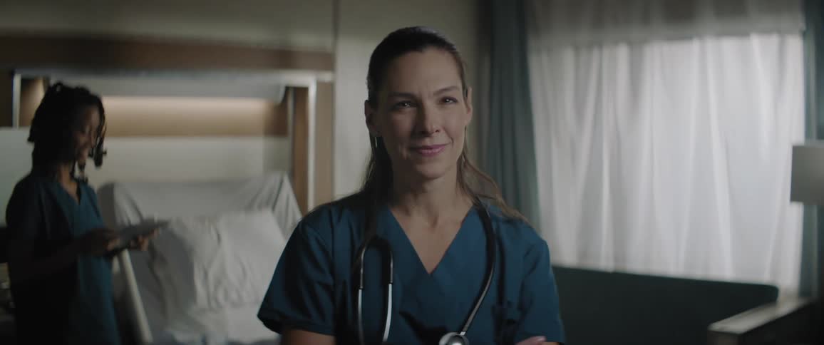 A doctor is smiling in the hospital room