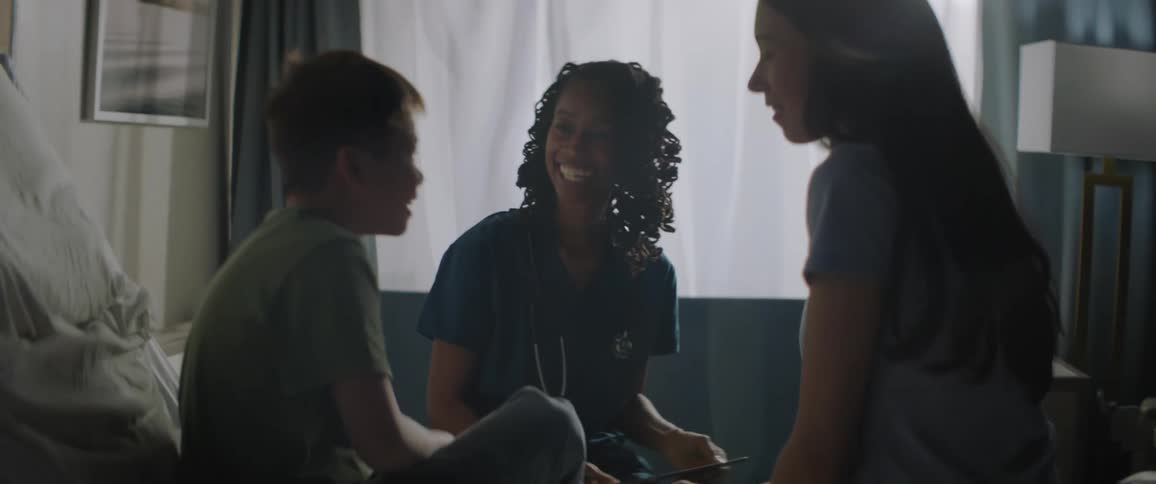 A doctor talking to her patient a smiling boy