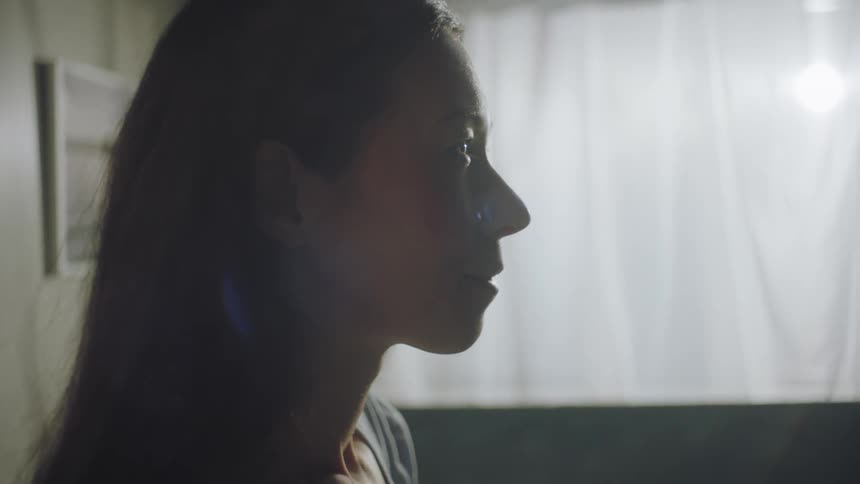 A woman is sitting in a hospital bed