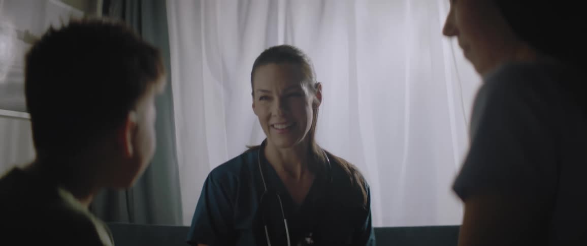 Nurse talking to a boy next to her