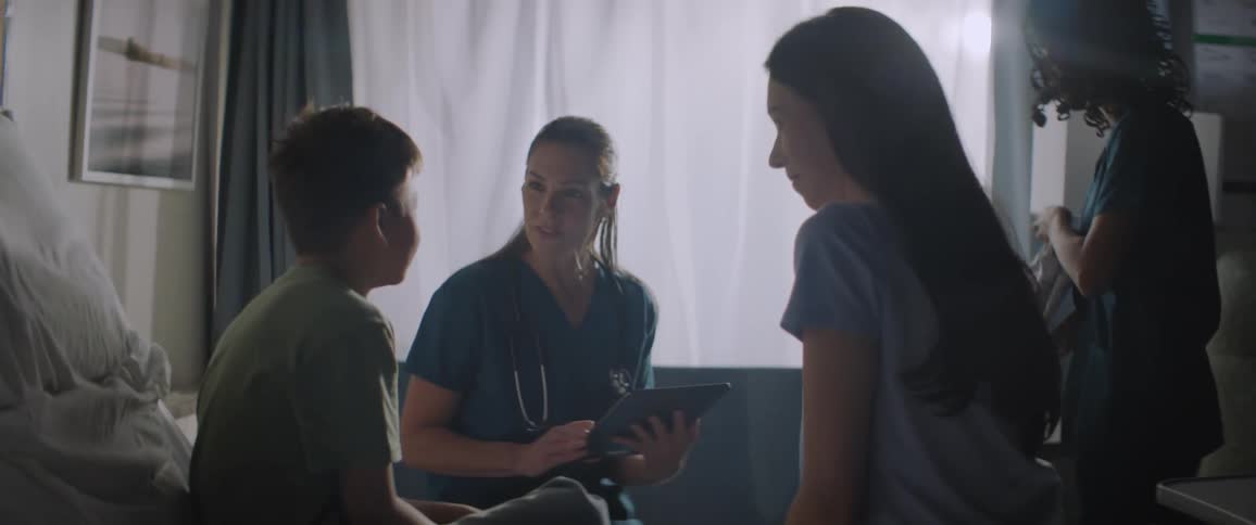 A doctor talks with a patient in the hospital