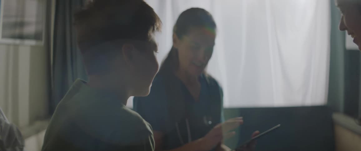 Nurse talking to a boy and the mother smiling