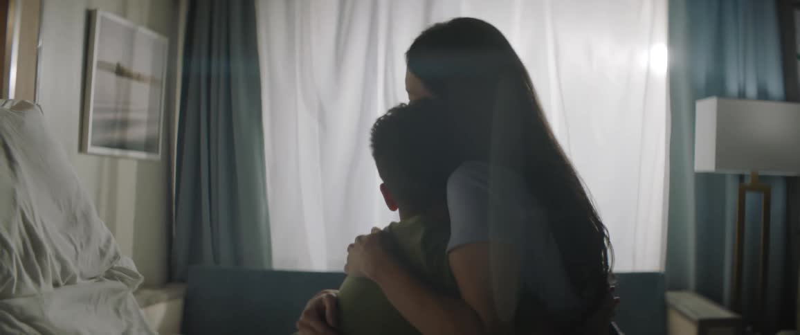 A clip of a mother and son conversating and then sharing a hug