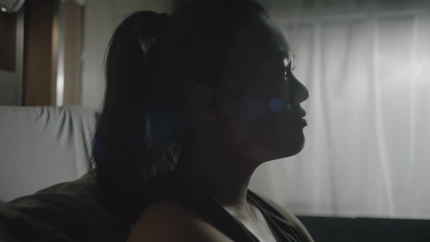Closeup of a womans face breathing deeply in a hospital room