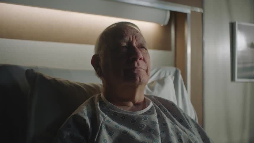 A patient in a hospital reading a newspaper