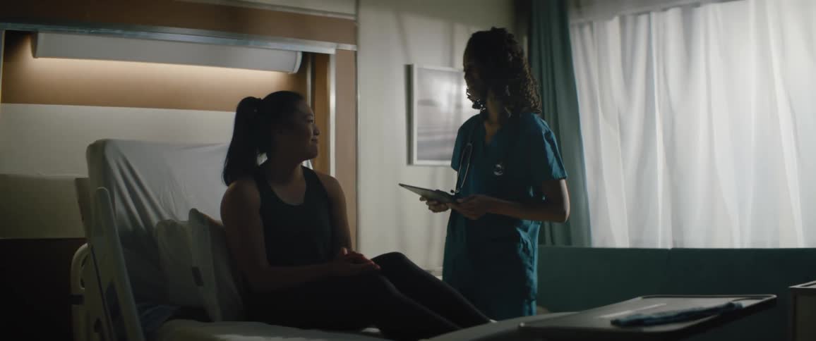 A doctor walks up to the patient to talk