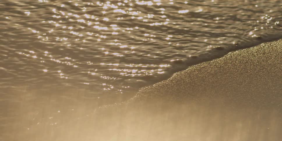 Glistening water flows onshore