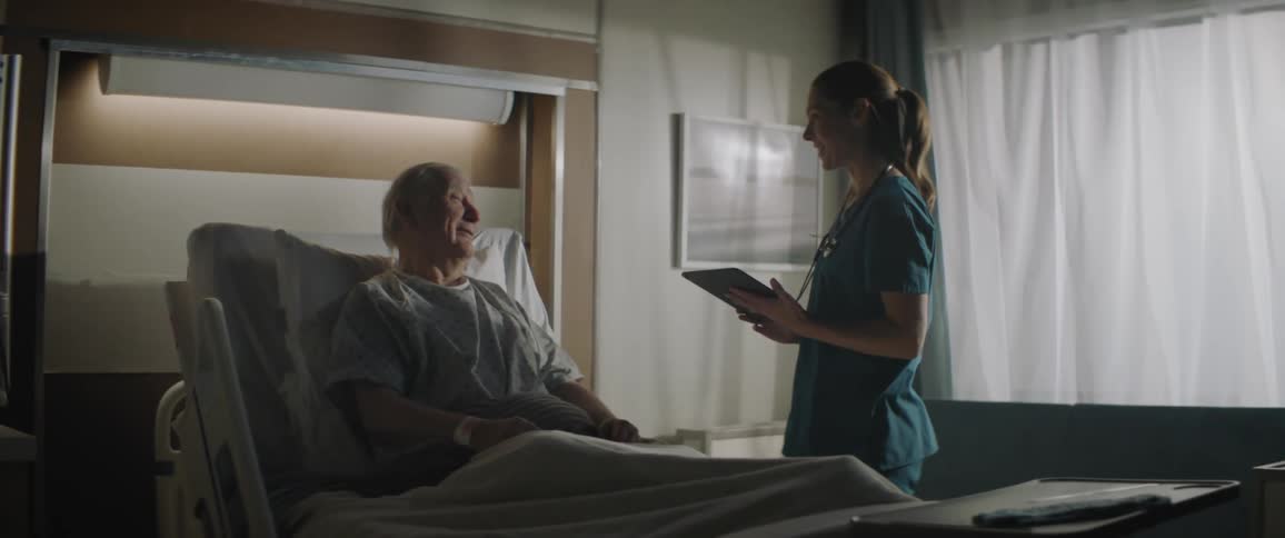 A doctor talks to a patient in the hospital