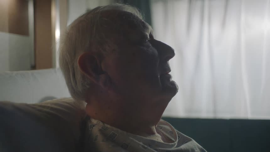 Portrait of an elderly patient sitting on a bed
