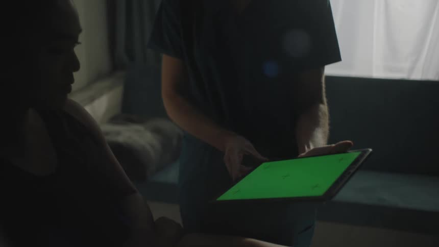 Nurse uses tablet to help patient understand what she is saying