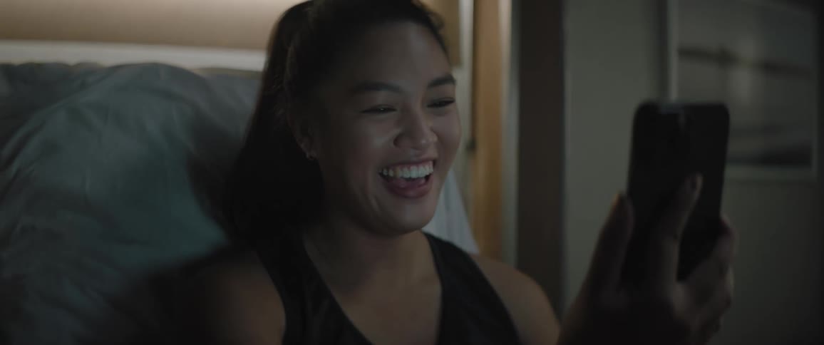 A woman video chatting with someone on her cell phone