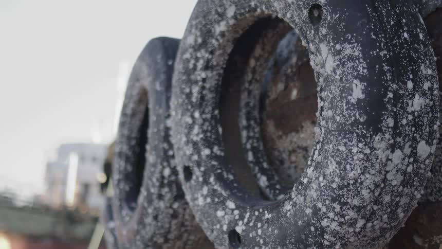 Closeup of two old tires on a vehicle