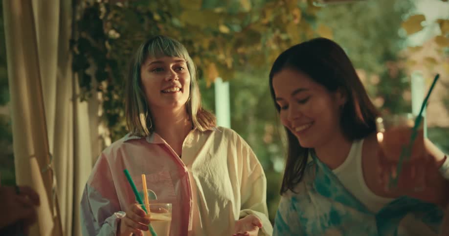 A group of people talking and happy get up from the table and toast their drinks