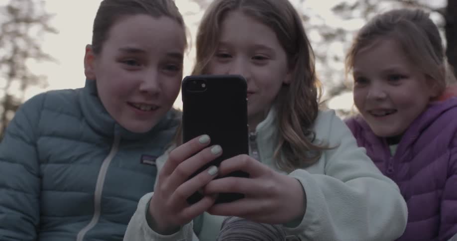 Two young girls smile and take a selfie