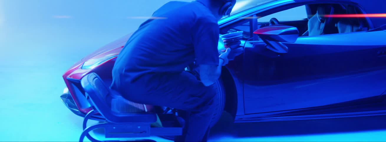 A man walks over to buff the car