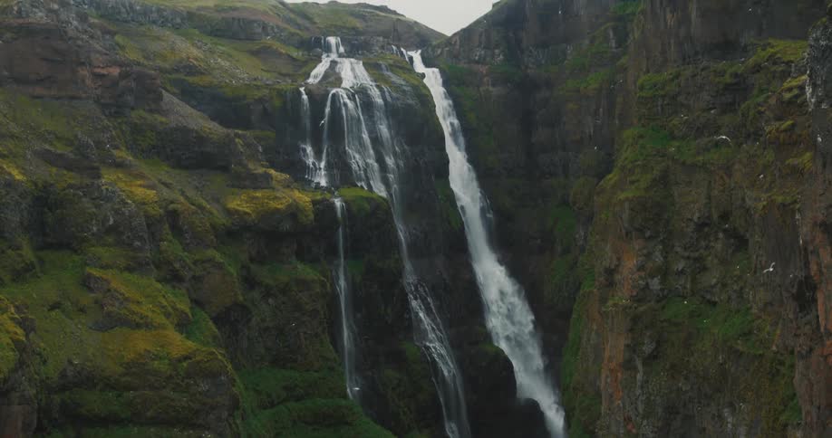 Panorama of a massive mountain with a waterfall in free fall