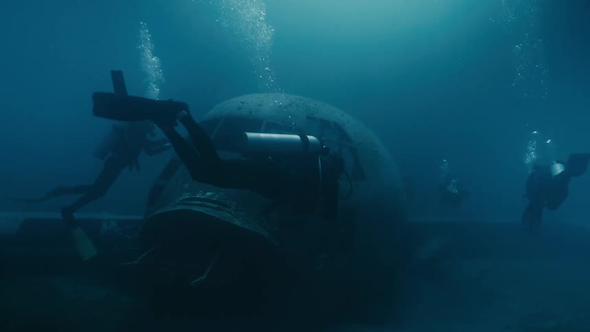 Divers investigating the wreckage of a sunken airplane