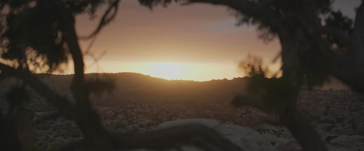 Sunset in a desert landscape with hills