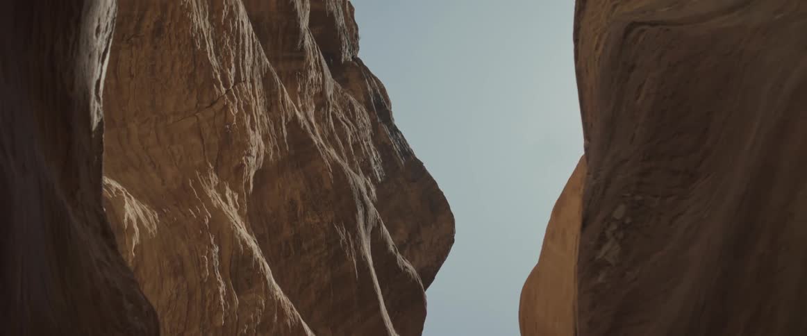 Upward view amidst valleys under a morning sky