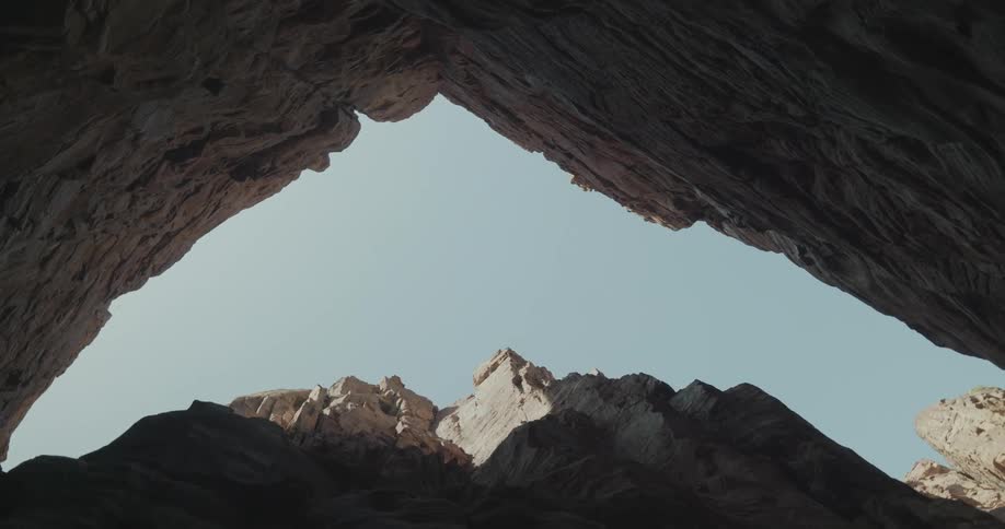 Upward view from inside a canyon with a clear blue sky and no clouds