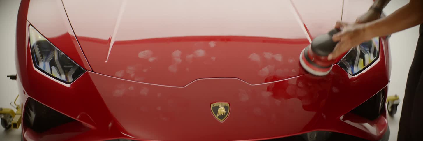 A man is buffing the sports car