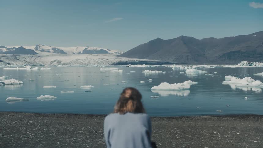A woman watching icebergs