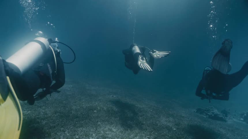 Three divers underwater in the sea