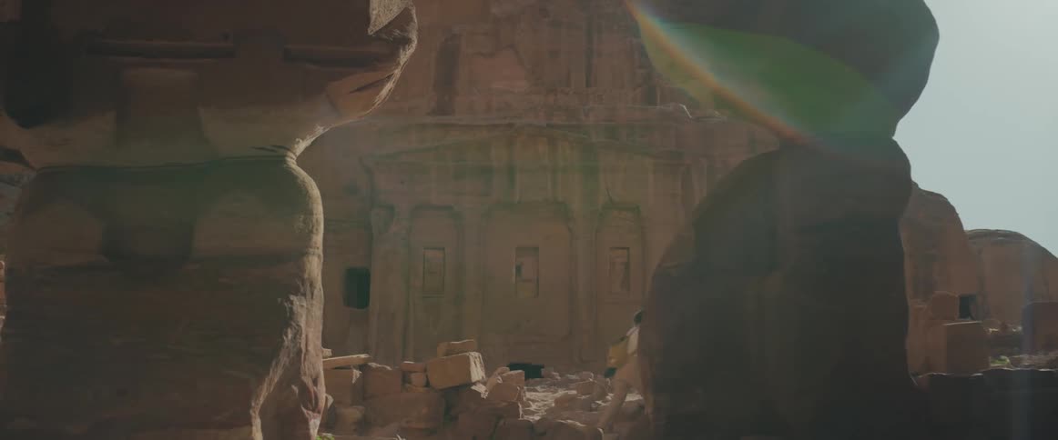 Woman visiting the ruins of a temple in the mountains