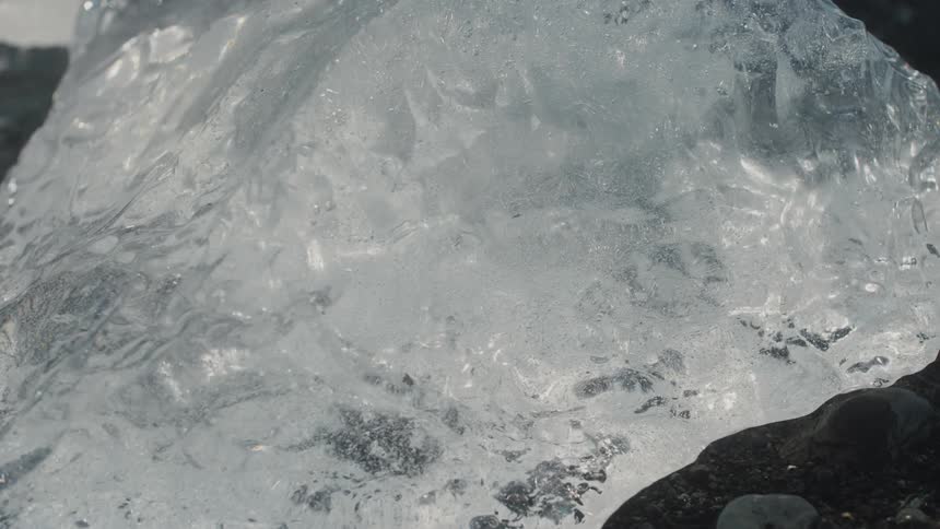 Closeup of ice among the rocks in the sea
