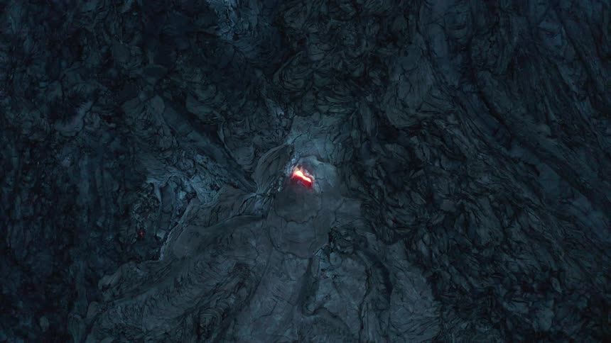 A hole with something shining in a place with a rocky surface