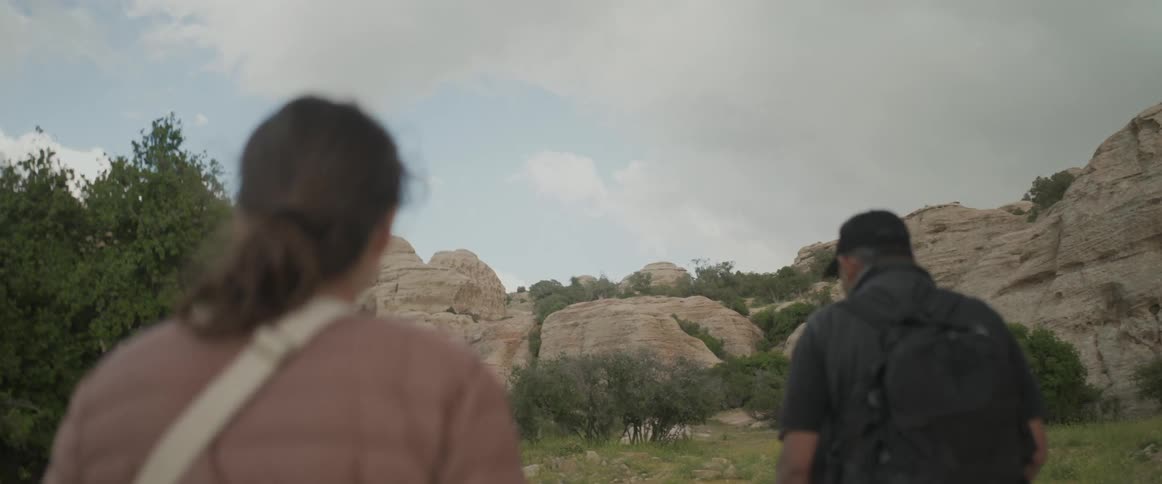 Two people walking amid nature in rocky and geological locations